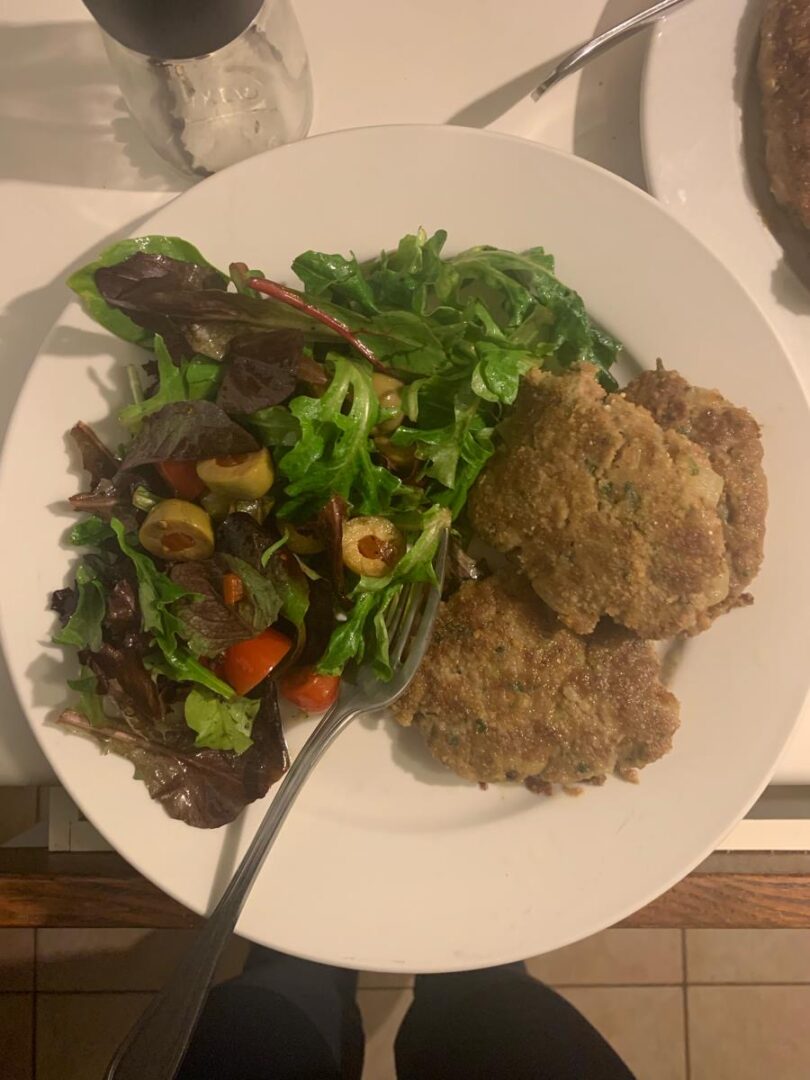 Homemade beef and zucchini burgers with a side salad