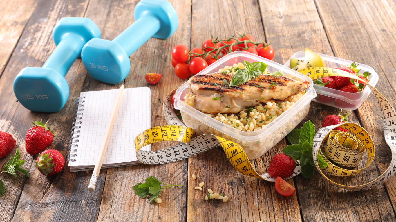 nutrition plan with chicken, vegetable and dumbbell